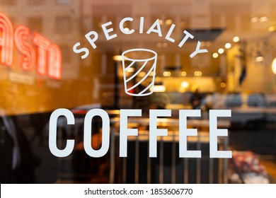 A restaurant window with a Specialty Coffee sign on it - Shutterstock ID 1853606770