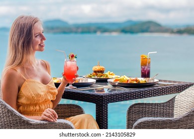 Restaurant Woman Drinking Tropical Cocktail Mocktail. Luxury Asia Travel Thailand Vacation. People Relaxing On Holidays On Sea View Terrace Of The Luxury Hotel