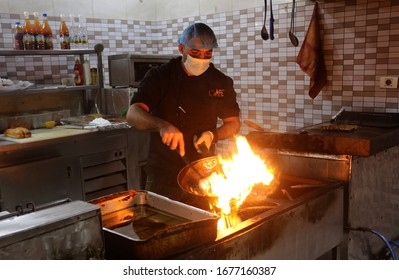 Restaurant Workers Wears A Mask On His Face While The Works At Of As A Precaution Against The Spread Of The COVID-19 Coronavirus,  In The Gaza Strip, On March 19, 2020. Photo By Abed Rahim Khatib