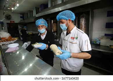 Restaurant Workers Wears A Mask On His Face While The Works At Of As A Precaution Against The Spread Of The COVID-19 Coronavirus,  In The Gaza Strip, On March 19, 2020. Photo By Abed Rahim Khatib