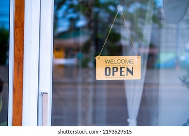 Restaurants And Businesses Reopening After Coronavirus A Female Employee Changes The Sign From A Closed Shop To An Open Door. Food Store Or Coffee Shop Business After Covid Lockdown
