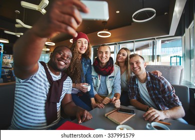 Restful Teenagers Making Selfie While Sitting In Cafe