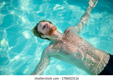 Resting, On Water. Young Bearded Male Swimmer Lying Calmly In The Water On His Back