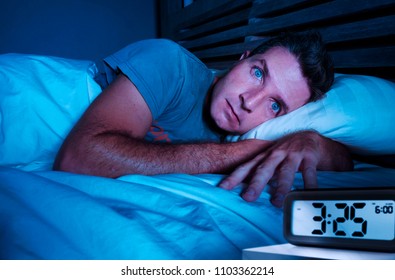 Restless Worried Young Attractive Man Awake At Night Lying On Bed Sleepless With Eyes Wide Opened Suffering Insomnia Sleeping Disorder Depressed And Sad In Rest Privation Stress Concept