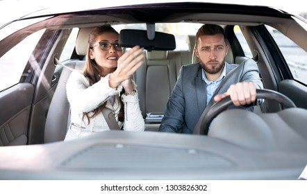 Restless Young Woman Sitting On A Co Driver’s Seat Looking Herself In The Mirror