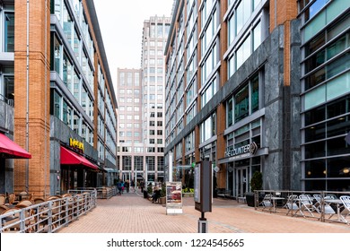 Reston, USA - April 11, 2018: Town Center Building Architecture, Sidewalk Street Road During Day, French Restaurant In Northern Virginia, People On Democracy Drive