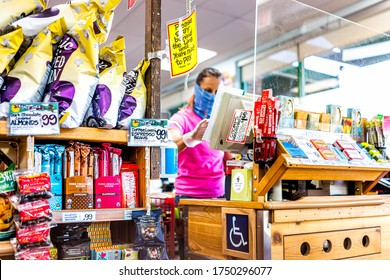 Reston, USA - April 9, 2020: Social Distancing Sign At Cashier Check-out Aisle Inside Trader Joe's Grocery Shop Store During Coronavirus With Woman Employee In Mask