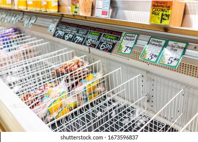 Reston, USA - March 13, 2020: Sold Out Empty Refrigerator Freezer Shelf Racks With Frozen Chicken Meat Food And Price Tags At Trader Joe's Store After People Stocking Hoarding For COVID-19 Coronavirus