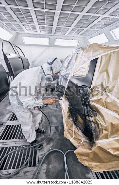 Restoration painting of a black car in the\
service center.