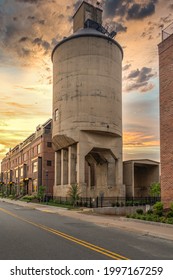 Restored concrete coal tower in Charlottesville Virginia used for supplying steam locomotives at the railway station, now integrated into a luxury house complex with dramatic sunset sky