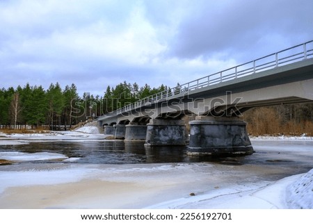 Restored, reconstructed concrete bridge over the longest river in Latvia, Gauja near the city of Strenci. Bridge over the river, spring