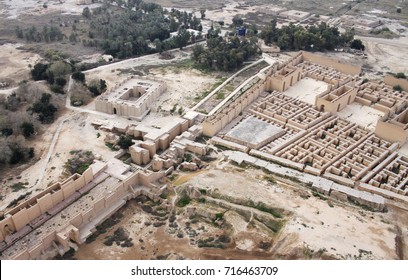 Restored Ruins Of The South Palace Of Nebuchadnezzar In Ancient Babylon, Iraq On The Right. Ruins Of The North Palace Damaged By US Occupation On The Left. Beyond Processional Street Is Ninmah Temple.