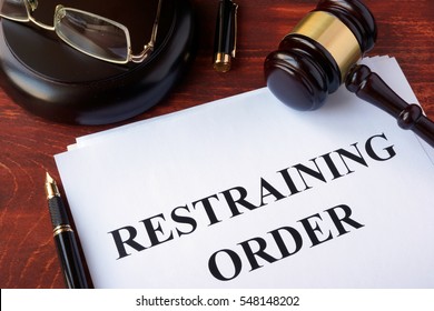 Restraining order and gavel on a table.