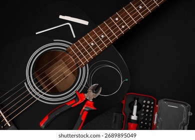 Restringing process with pliers and screwdriver kit near acoustic guitar. Guitar string replacement with tools. Acoustic guitar setup in progress with new strings and essential tools on the table