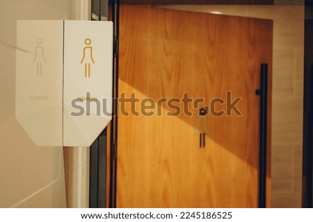 Restroom sign on a toilet door. Men and women WC signs for restroom.