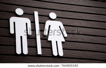 Restroom sign on a toilet door,on wood background.Toilet sign - Restroom Concept - black tone.WC / Toilet icons set. Men and women WC signs for restroom.