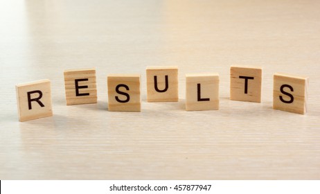 Results Word On Wooden Desk Table. Succeed Business Success Be A Winner In Business Elections, Pop Poll, Sports Test, Report, Election Result. Counting Losses And Profit Analyzing Financial Statistics