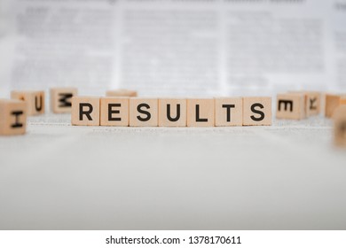 Results Word Written In Wooden Cube - Newspaper 