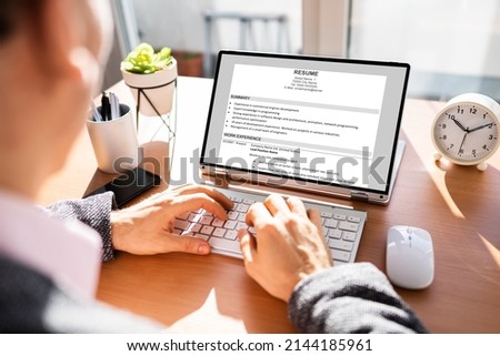 Resume CV Preparation On Laptop Computer. Recruitment And Unemployment