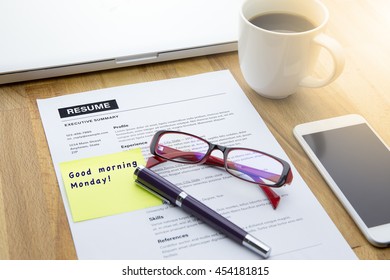 Resume information and paper note with good morning Monday message with pen, computer laptop, glasses, a cup of coffee and smart phone. - Shutterstock ID 454181815