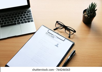 resume on wooden table in the modern office - Shutterstock ID 764246563