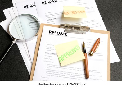 Lot Of Resume Templates On Black Background.Recruiter Making Decision. Concept Of Reviewing Resume Applications