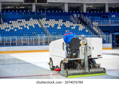 Resurfacing machine cleans ice of hockey rink