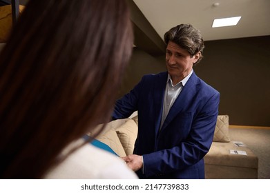 Retail Assistant And Customer In The Showroom Of A Furniture Store. Home Improvement And Interior Design Concept