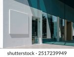 Retail shop store front or commercial office space on ground level of building, with sunlight and shadows on wall. Background for brand logo mockup template..