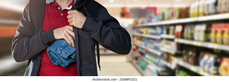 Retail Shoplifting. Man Stealing Jeans. Theft At Shop