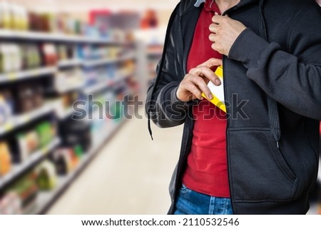 Retail Shoplifting. Man Stealing In Supermarket. Theft At Shop Foto stock © 