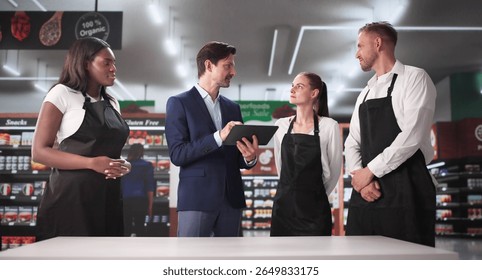 Retail Store Manager Using Tablet To Plan Sales Strategy