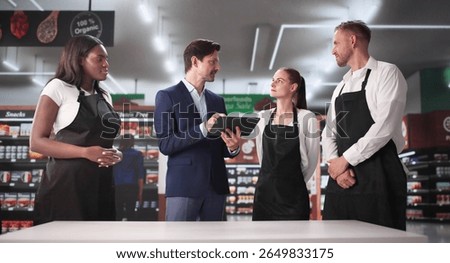 Retail Store Manager Using Tablet To Plan Sales Strategy