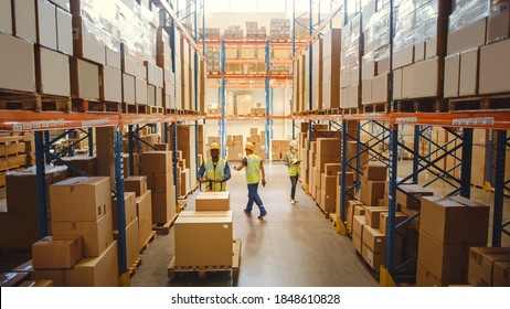 Retail Warehouse full of Shelves with Goods in Cardboard Boxes, Workers Scan and Sort Packages, Move Inventory with Pallet Trucks and Forklifts. Product Distribution Logistics Center. Elevated Shot