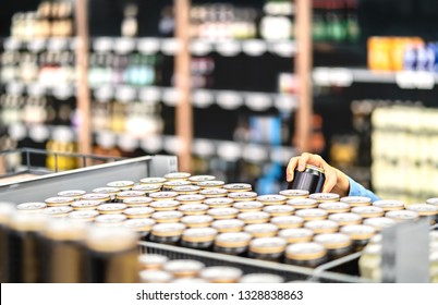 Retail Worker Filling Shelf With Drinks In Grocery Store Or Customer Taking Can Of Beer Or Soda. Staff At Supermarket Stocking Shelf With Alcohol Or Doing Inventory. Woman Buying Liquor In Shop.