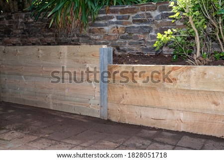 Retaining Wall, built with pressure treated Structural Pine, terraced garden beds.