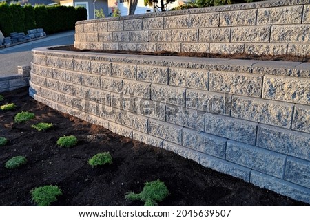 retaining wall closeup 2 tier wall gray concrete block new construction concrete block wall 