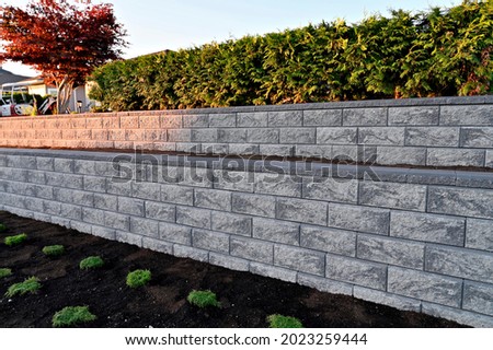 retaining wall gray concrete blocks two tier wall straight closeup 