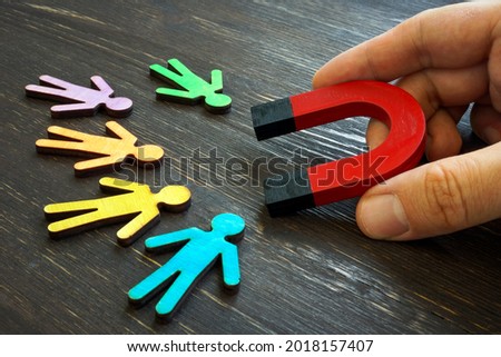 Retention marketing concept. The manager holds a magnet for customers.