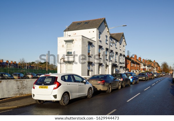 Retford, Nottinghamshire, UK.\
January 27th 2020. Typical urban street in an English market town\
in the North of England rows vehicles outside Terraced street\
housing.