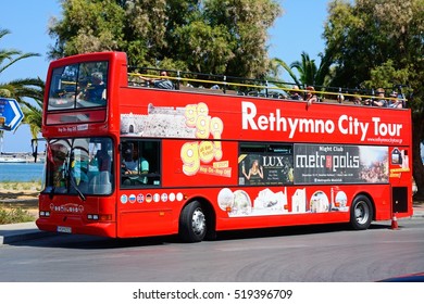 RETHYMNO, CRETE - SEPTEMBER 15, 2016 - Tourists aboard a red open topped Rethymno City Tour bus, Rethymno, Crete, Greece, Europe, September 15, 2016.