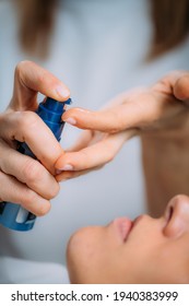 Retinol Treatment. Cosmetician Applying Retinol Serum On Woman’s Face