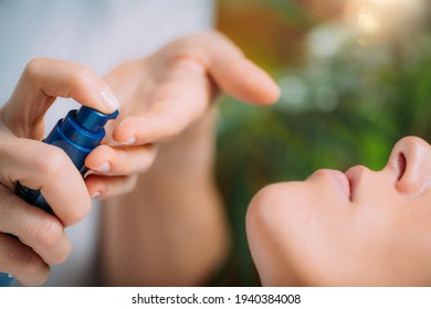 Retinol Treatment. Cosmetician Applying Retinol Serum On Woman’s Face