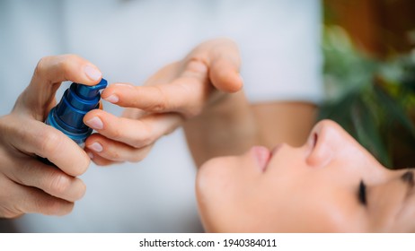 Retinol Treatment. Cosmetician Applying Retinol Serum On Woman’s Face