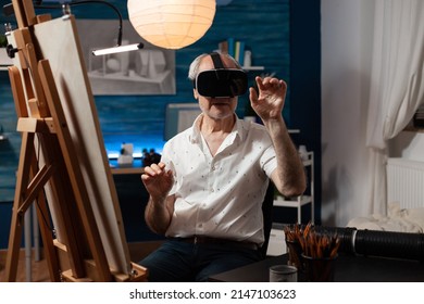 Retired Art Teacher With Modern Technology Vr Goggles Looking At 3d Artwork In Creative Workshop. Senior Sketch Artist Using Virtual Reality Glasses Doing Air Gesture Improving Freehand Technique.