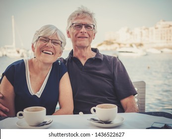 Retired couple enjoying coffee on a resort - Powered by Shutterstock