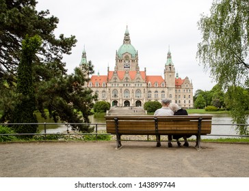 A Retired Couple In Front Of The New Town-hall Of Hannover/Germany