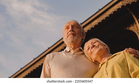 Retired couple hugging and looking into distance, happy marriage, social security - Shutterstock ID 2255605547