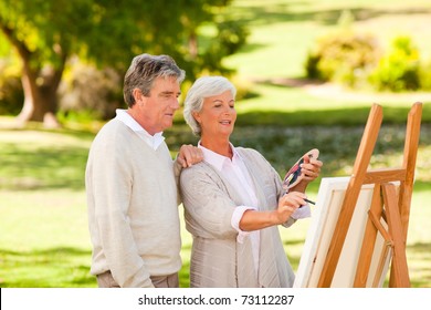 Retired couple painting in the park - Powered by Shutterstock