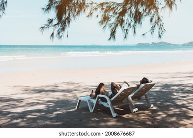 Retired Couple Resting On A Adirondack Chair By The Beach In The Sunlight. Retirement Planning Ideas And Happy Life.